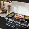 Rangemaster Edge Deluxe 100 Induction Range Cooker in Black Glass with Chrome Trim - EDDL100EIGBLK/CM1_cook